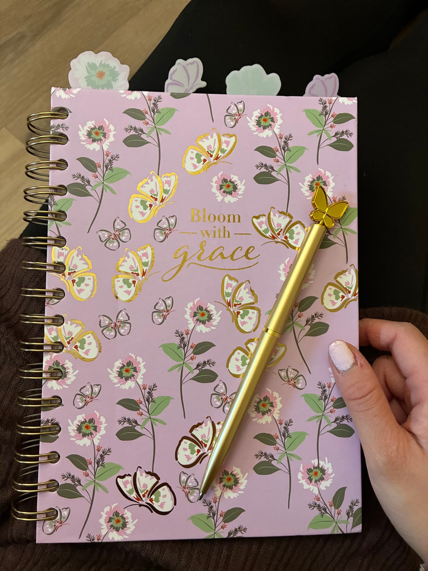 Bloom with Grace journal with gold butterflies and blooming flowers, with the golden butterfly pen resting on top